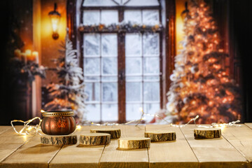 Yellow old wooden table and free space for your decoration. Blurred home interior with christmas tree. Empty space for your products. Mockup background and magic december time. Natural light.