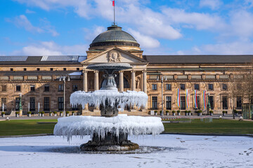 The fountain covered in ice in front of the casino in Wiesbaden/Germany