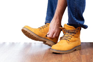 Man zips up his winter nubuck boots. Mens winter leather shoes