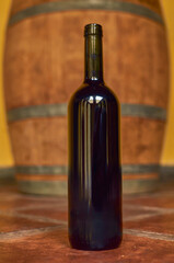 lose up of a wine bottle with a rustic background and a barrel