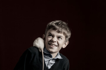 Portrait image of a boy with a white rat