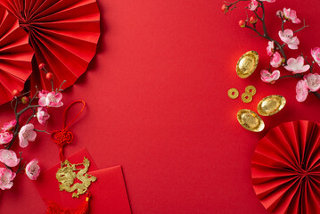 Dive into festive aura with top-view shot featuring fans, Feng Shui trinkets, traditional coins,...
