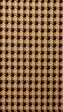 A brown and tan houndstooth pattern with an oval shape in the middle