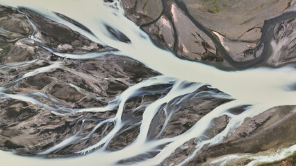 Aerial view of patterns of Icelandic rivers flowing into the ocean. Iceland - 682434910
