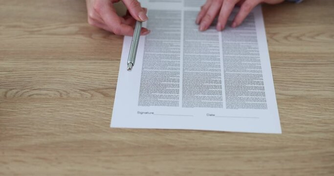 Offering to sign contract concept business woman offers to read terms of deal on business paper