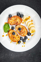breakfast French toast sweet berries, banana pancake cooking appetizer meal food snack on the table copy space food background rustic top view