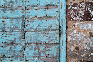rustic old painted window or door in stone building house, abandoned property