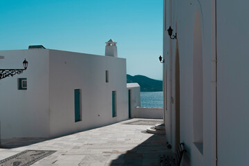 view from the greek church in milos to the sea harbour, white building, blue sky, travel exprerience