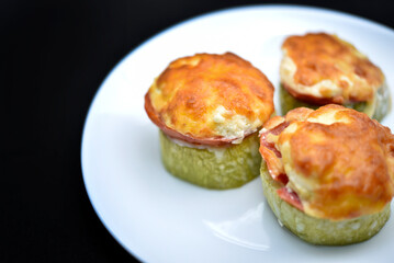 Pieces of grilled meat under cheese. Delicious meat appetizer. Fried food.