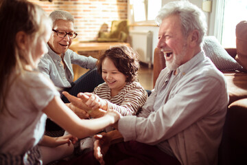 Grandparents having fun with Grandkids in the living room