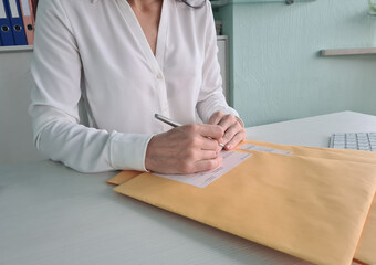 Woman secretary checks received correspondence at workplace concept