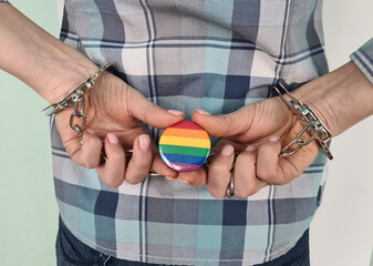 Closeup of young woman hands in handcuffs