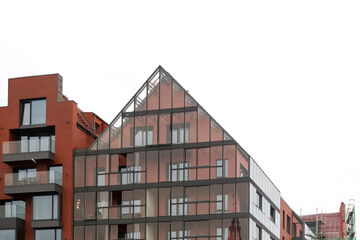 Modern glass and red brick buildings in minimalism style. New modern block of flats in Gdansk. Triangle roof