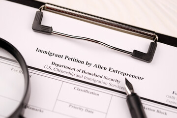 I-526 Immigrant Petition by Alien Entrepreneur blank form on A4 tablet lies on office table with...