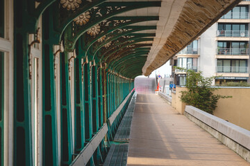Fototapeta premium Relaxing place in the centre of Blankenberge, coast of Belgium. Covered green benches overlooking the harbour