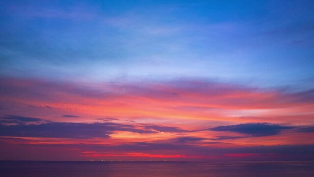 .Aerial hyperlapse sweet sky cloud scape in colorful sunset..colorful light through to the cloud above the ocean..Nature video High quality footage .Scene of Colorful romantic sky sunset background.
