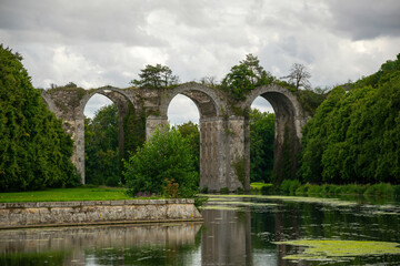 old stone aqueduct over the river in summer