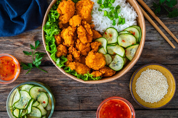 Korean fried chicken - seared breaded chicken nuggets served with white rice and vegetables on...
