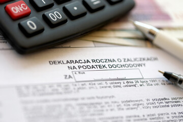 Annual declaration of income tax advances, PIT-4R form on accountant table with pen and polish...