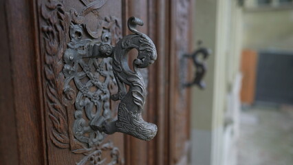 Beautiful door knob in traditional antique wooden doorway with adornment and ornamentation