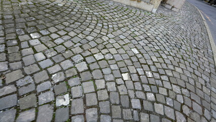 Ancient old cobblestone walkway POV of person walking in European sidewalk