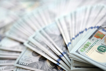 Very big amount of US hundred dollar bills close up. Huge quantity of united states currency notes on flat table