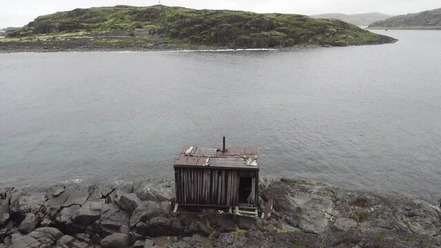 This is the Arctic. Old hunting fishing hut in the skerries (skargard - rocky islets along a rugged coast) of north-eastern Scandinavia. The coast of the Barents Sea