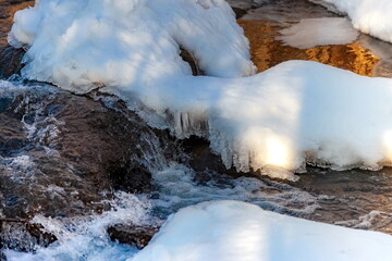 The rapid flow of the river with snow and ice is a large plan of suspension