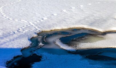 Spring snow-covered ice floes on the river close-up