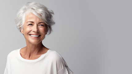 beautiful elderly woman model with beautiful gray hair smiling in the studio isolated on white background. copy space