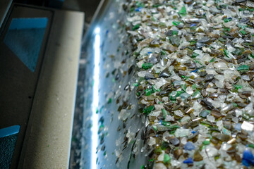 A machine separates the pieces of glass for recycling by color