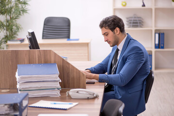 Young male employee working in the office