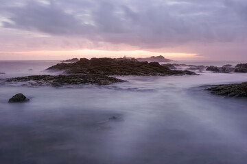 Fototapeta na wymiar Rocky sea beach at dusk