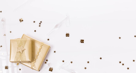 Minimalistic Christmas background, golden gifts and sparkles on a white background