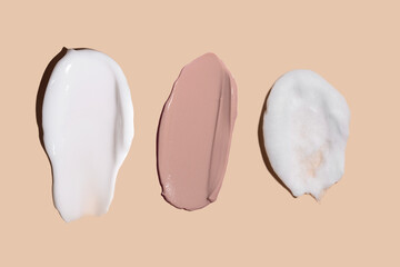 Set of cream texture cosmetic strokes on a beige background. Skin care. Tonal cream for the face.