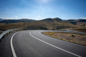 The desolate, empty and inviting highway stretching serpentine across the steppe. It is said that distance first accumulates inside a person, then it is only the road . Kars, Turkey.