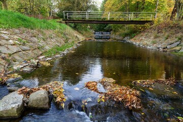Rapids, bridge and weir. River Juhyne near the village of Komarno. Moravia. Czechia. 