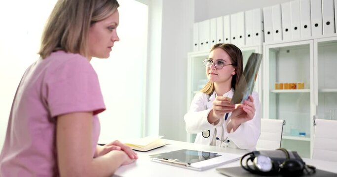 Doctor is talking and looking at x-ray film with picture of lungs. Inflammation of the lungs pneumonia and treatment