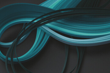 Blue neon color strip wave quilling paper on black. Abstract texture copy space background.