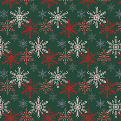 Winter seamless pattern with snowflakes in red-green tones. New Year and Christmas design.