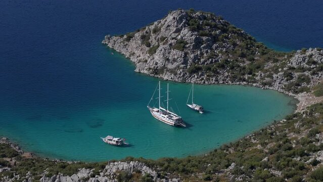 Boats anchored in the blue bay and people on holiday
