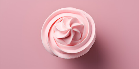 Top view of vanilla cupcake with pink frosting on top, pink background with copy space 