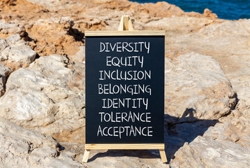 Diversity equity inclusion belonging symbol. Diversity equity inclusion belonging identity tolerance acceptance words written on blackboard on beautiful stone background. Diversity belonging concept.