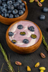 Fototapeta na wymiar fresh purple and white yogurt with blueberries and blueberry berry flavor