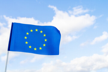 Flag of the European Union against a blue sky.