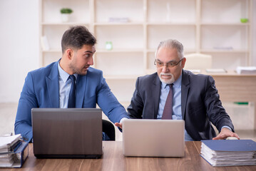 Two male employees working in the office