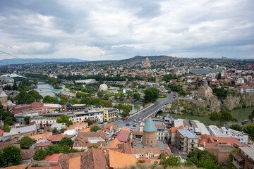 Fototapeta na wymiar The Kura river, The Bridge of Peace, the cathedral, churches and the magnificent view of Tbilisi city from the cable car.