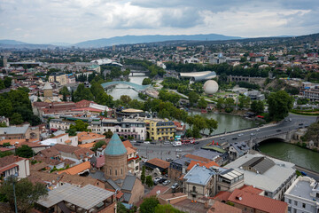 Fototapeta na wymiar The Kura river, The Bridge of Peace, the cathedral, churches and the magnificent view of Tbilisi city from the cable car.