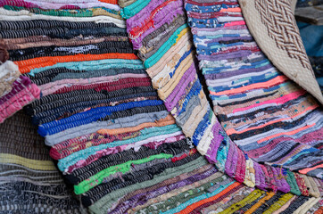 crocheted blankets laid out to dry in a rural village