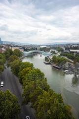Fototapeta premium The Kura river, The Bridge of Peace, the cathedral, churches and the magnificent view of Tbilisi city from the cable car.